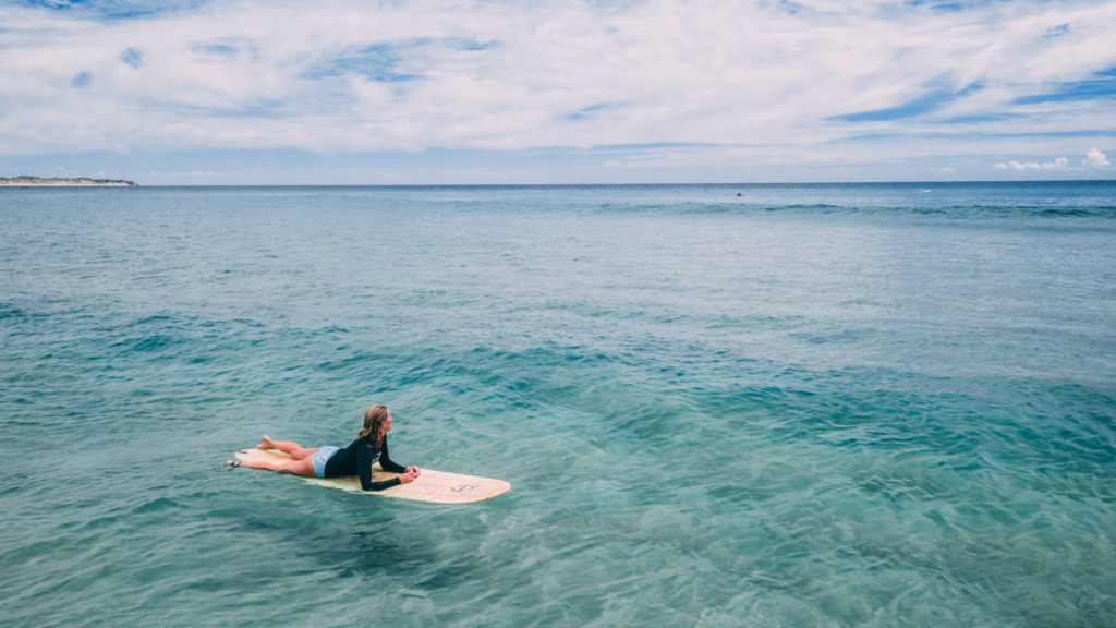 woman on surfboard in water