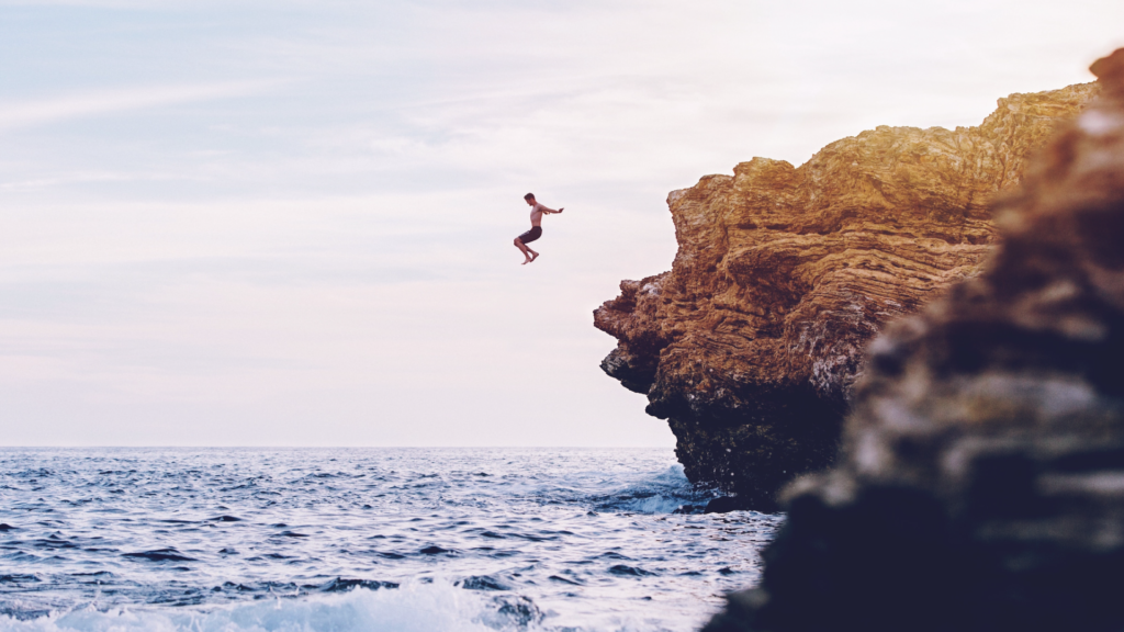 guy jumping a cliff