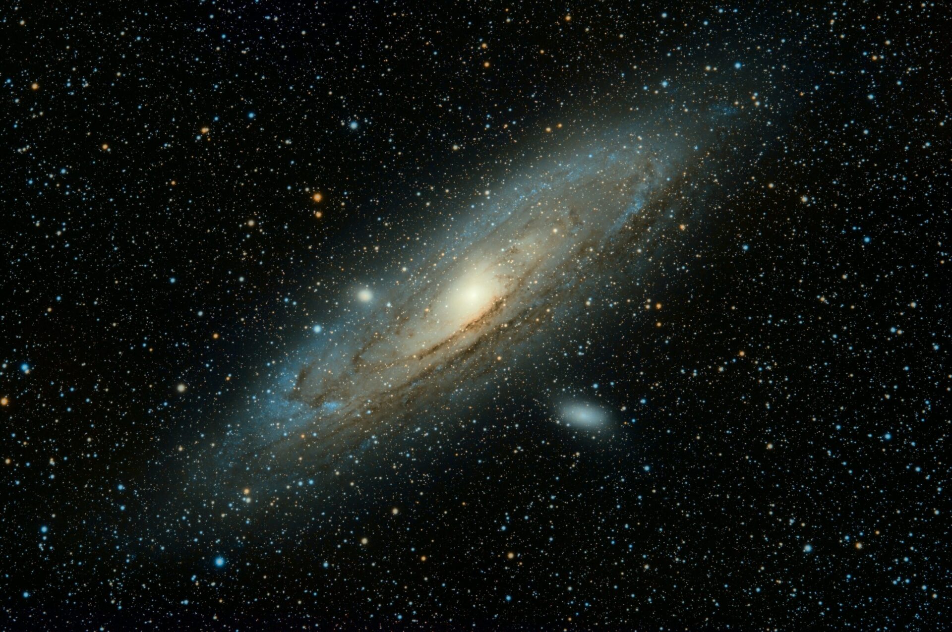 An image of an oblong galaxy in outer space.